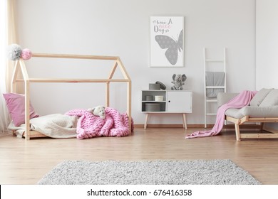 Cozy Baby Girl Room With Positive Poster Of A Butterfly On The Wall