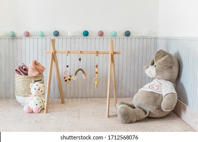 Cozy Baby Nursery Room, Trendy Wooden Baby Gym On Play Mat