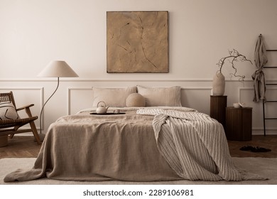 Cozy bedroom interior with mock up poster frame, big bed, beige bedding, plaid, lamp, wooden stands, black ladder, beige rug, wall with stucco and personal accessories. Home decor. Template. - Shutterstock ID 2289106981