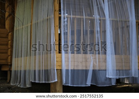 Similar – Space. Wallpaper with forest motif, in the mirror is reflected a red and white chequered curtain and a neon tube. Lost taste, in need of renovation.