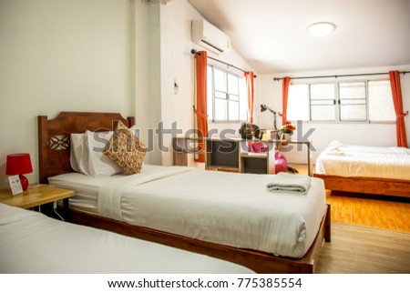 The cozy bedroom with the soft light control decoration with accomodation such as bed pillows and flowers.