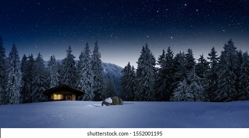 cozy blockhouse in wintertime at night - Powered by Shutterstock