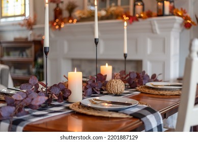 Cozy candlelit table in a dining room decorated for fall