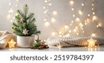 Cozy Christmas decoration with mini Christmas tree and lights on snowy background