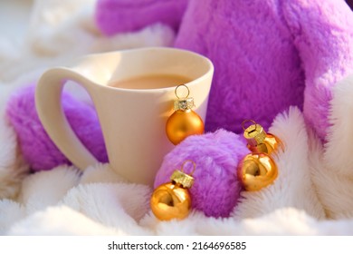 Cozy Christmas Home Decor. 
White Cup And Fluffy Toy With  Golden Christmas Bauble. Festive Decorations. Shallow DOF