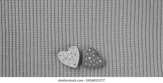 Cozy Comfort with a Touch of Love. Two Polka Dot Heart Buttons on a Knitted Grey Sweater - Powered by Shutterstock