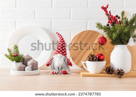 Cozy, comfortable interior design, decorated for the holiday of the New Year. Kitchen countertop with New Year's dishes, decorations, candles