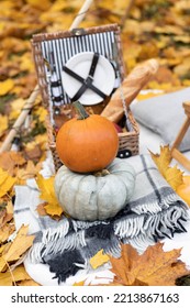 Cozy Composition Of Autumn Picnic Outdoors. Rustic Decor With Orange Pumpkin, Wooden Basket, Plaid, Delicious Food. Fall Vibes