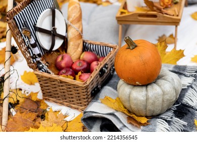 Cozy Composition Of Autumn Picnic Outdoors. Rustic Decor With Orange Pumpkin, Wooden Basket, Plaid, Delicious Food. Fall Vibes