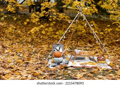 Cozy Composition Of Autumn Picnic Outdoors. Rustic Decor With Orange Pumpkin, Wooden Basket, Plaid, Delicious Food. Fall Vibes