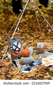 Cozy Composition Of Autumn Picnic Outdoors. Rustic Decor With Orange Pumpkin, Wooden Basket, Plaid, Delicious Food. Fall Vibes