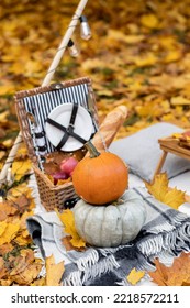 Cozy Composition Of Autumn Picnic Outdoors. Rustic Decor With Orange Pumpkin, Wooden Basket, Plaid, Delicious Food. Fall Vibes