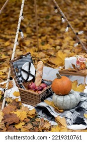 Cozy Composition Of Autumn Picnic Outdoors. Rustic Decor With Orange Pumpkin, Wooden Basket, Plaid, Delicious Food. Fall Vibes