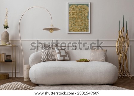 Cozy composition of living room interior with mock up poster frame, white sofa, green pillows, gold trace, plants, beige lamp, wall with stucco and personal accessories. Home decor. Template. 