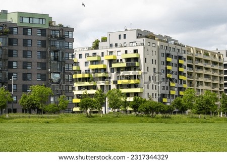 Cozy district of Vienna in Austria - new modern colorful European multi-story houses among trees.