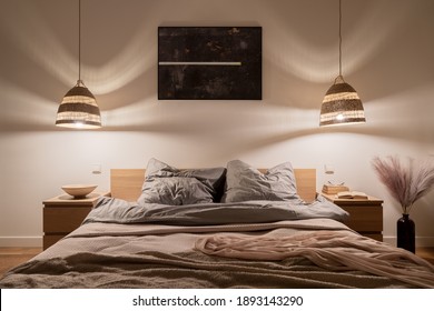 Cozy And Elegant Bedroom With Big Bed, Nice Bedclothes, Wooden Bedside Tables And Rattan Pendant Lamps With Warm Light