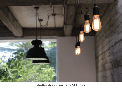 In a cozy café, elongated tubes suspended from the ceiling. These are the enchanting light fixtures that grace the café's interior, casting a warm and inviting ambiance throughout the space.