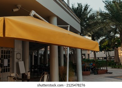 Cozy Empty Terrace Of The Outdoor Cafe Restaurant With Wooden Table With No People