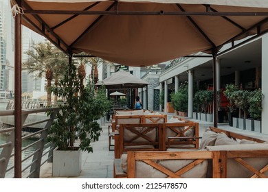 Cozy Empty Terrace Of The Outdoor Cafe Restaurant With Wooden Tables And No People