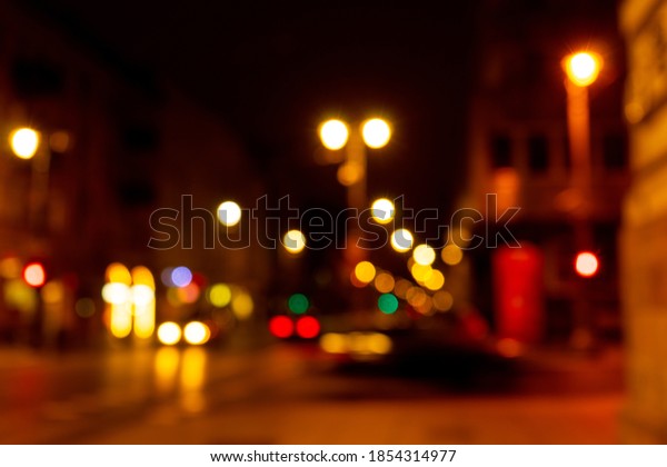 Cozy evening in the festive city. Blurred\
image of street with lights for Christmas and New Year celebration\
time or calm evening. Shining avenue at midnight. Abstract holiday \
background.