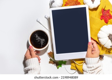 Cozy Fall Background With Coffee Cup, Tablet Notebook, Ear-pods, White, Orange Pumpkins, Autumn Leaves Decor On White Home Office Table Background. Autumn Still Life Composition Flatlay