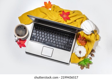 Cozy Fall Background With Coffee Cup, Tablet Notebook, Ear-pods, White, Orange Pumpkins, Autumn Leaves Decor On White Home Office Table Background. Autumn Still Life Composition Flatlay