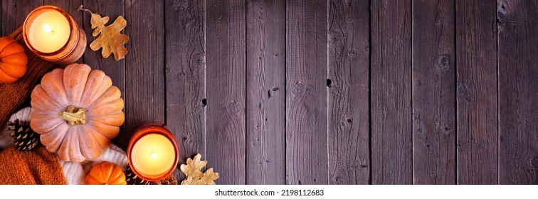 Cozy Fall Corner Border With Pumpkins, Sweaters And Candles. Top Down View Over A Dark Wood Banner Background.