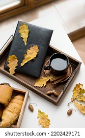 Cozy Fall Morning At Home. Coffee Cup, Book And Autumn Leaves On Wooden Tray.