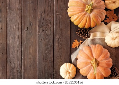 Cozy Fall Side Border On A Rustic Dark Wood Background. Overhead View. Blanket, Pumpkins And Natural Decor. Copy Space.