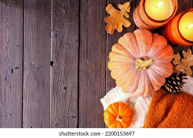 Cozy Fall Side Border With Pumpkins, Sweaters And Candles. Overhead View Over A Dark Wood Background.