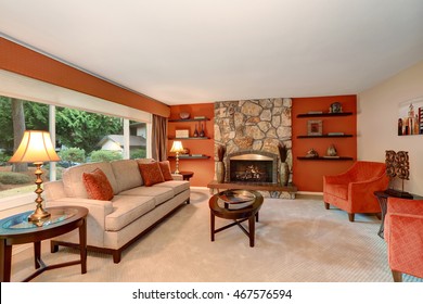 Cozy Family Room In Red Tones With Stone Fireplace And Some Shelves. Northwest, USA