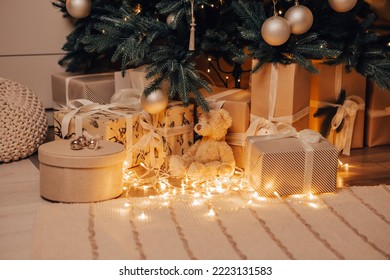 Cozy flat apartment room green Christmas Tree gifts presents garlands, candles decorated toys balls interior New Year beautiful living room in the evening, lights glowing bokeh - Powered by Shutterstock