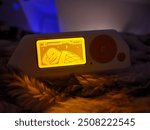 A cozy Flipper Zero sleeping on a soft, fluffy bed illumated with a soothing orange glow