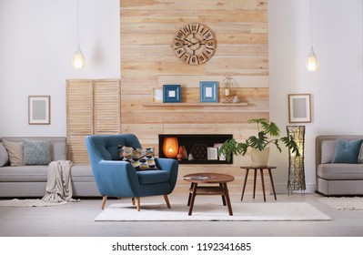 Cozy furnished apartment with niche in wooden wall and armchair. Interior design - Shutterstock ID 1192341685