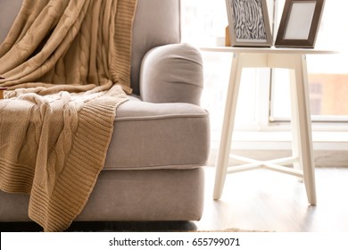 Cozy Grey Couch With Plaid In Modern Room, Close Up