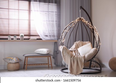 Cozy Hanging Chair With Fairy Lights In Modern Living Room. Interior Design