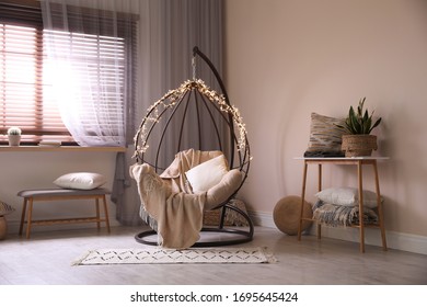 Cozy Hanging Chair With Fairy Lights In Modern Living Room. Interior Design