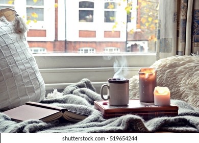 Cozy Home. Candles, Book And Cup Of Tea