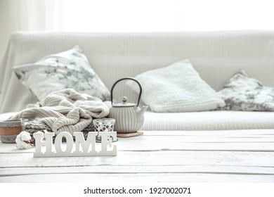 Cozy Home Composition With A Teapot, Knitted Items And Scandinavian Decor Details. The Concept Of Home Comfort And Modern Style.