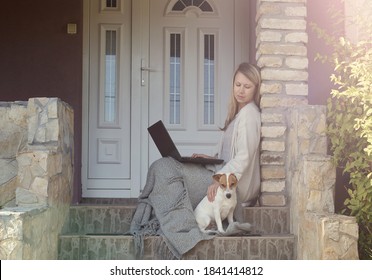 Cozy Home, Dog Sitting Next To Woman Using Laptop , Sitting On Steps On A Front Porch. Relax, Carefree, Comfort Lifestyle.