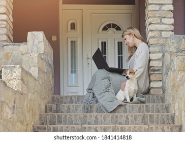 Cozy Home, Dog Sitting Next To Woman Using Laptop , Sitting On Steps On A Front Porch. Relax, Carefree, Comfort Lifestyle..