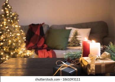 Cozy Home Interior In Living Room With Christmas Tree, Sofa, Wooden Tabletop And Candles. Xmas Holiday At Home.