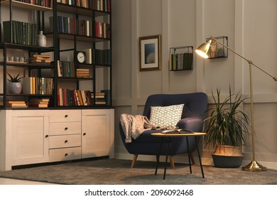 Cozy home library interior with collection of different books on shelves and comfortable place for reading - Shutterstock ID 2096092468