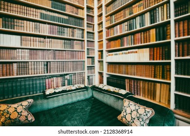 Cozy Home Library Interior With Comfortable Armchair And Collection Of Vintage Books On Shelves