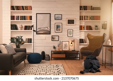 Cozy Home Library Interior With Comfortable Furniture And Collection Of Different Books On Shelves