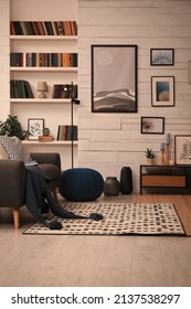 Cozy Home Library Interior With Comfortable Sofa And Collection Of Different Books On Shelves