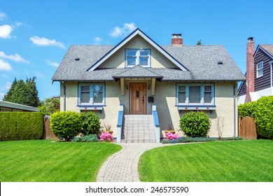 Cozy House With Beautiful Landscaping On A Sunny Day. Home Exterior.