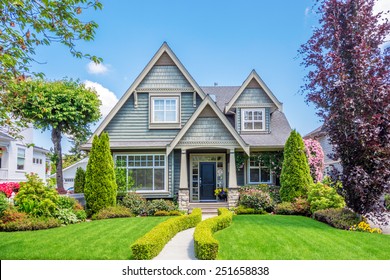 Cozy House With Beautiful Landscaping On A Sunny Day. Home Exterior.