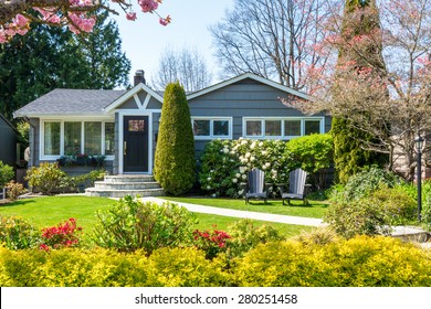 Cozy House With Beautiful Landscaping On A Sunny Day. Home Exterior.