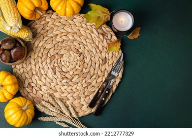 Cozy Hygge Table. Top View Of Wicker Straw Place Mat, Pumpkins, Autumn Leaves And Cutlery On Green Table. Autumn Table Setting. Festive Thanksgiving Background. Restaurant Menu